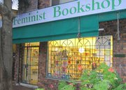 Shop front of Feminist Book shop is closed but lights are on inside