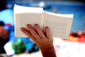 A book being held in the air as an example of a good book. 