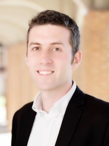 Head shot of Tab Betts, smiling at the camera.
