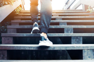 Photograph of a person climbing some steps.