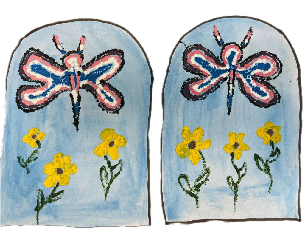 A moccasin vamp illustration with two arch shapes representing the tops of a pair of  moccasins. The two shapes are nearly identical. At the bottom are three yellow flowers on green stems. Above is a blue, pink and black butterfly. The background colour is sky blue.