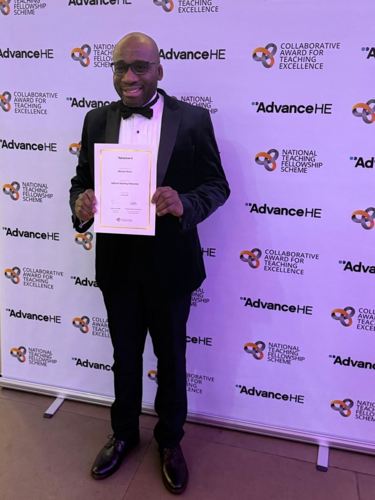 Photograph of Professor Michael Okorie collecting his prestigious National Teaching Fellowship
