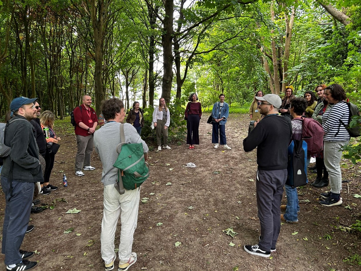 People gathering in Stanmer woods surrounded by trees