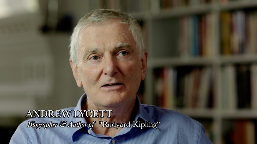 A portrait of Andrew Lycett with a book case in the background