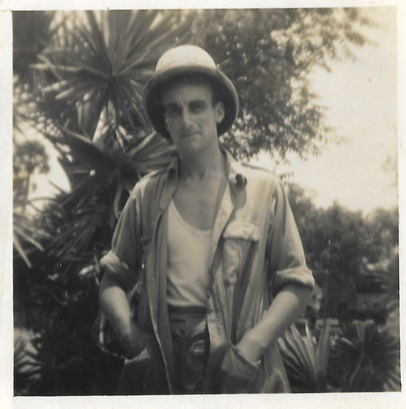 A man wearing 1940s military uniform in the jungle.