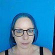 Profile photo of Victoria Grace Walden - blue hair and glasses against a matching blue background.