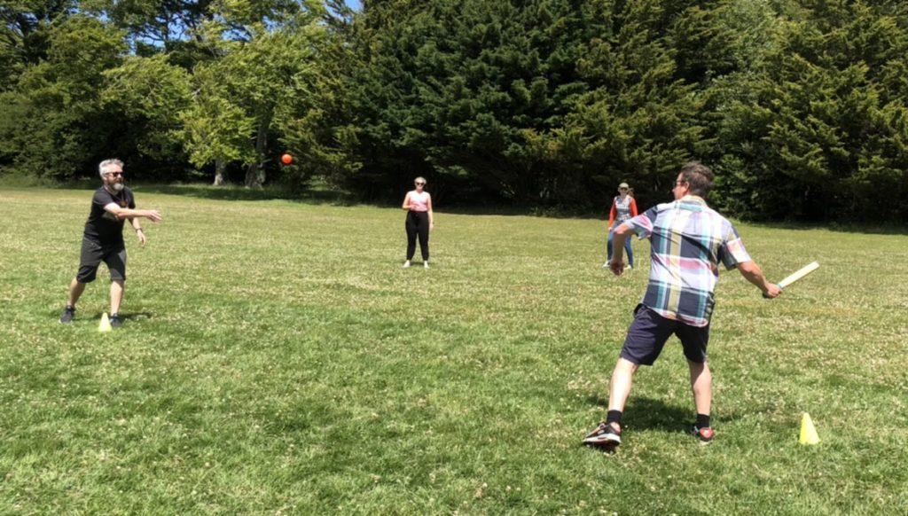 Members of the EE team play rounders in the park